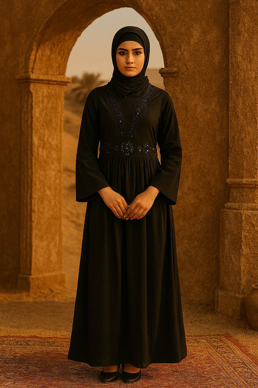 Woman in a black dress standing in front of an archway with a warm-toned background