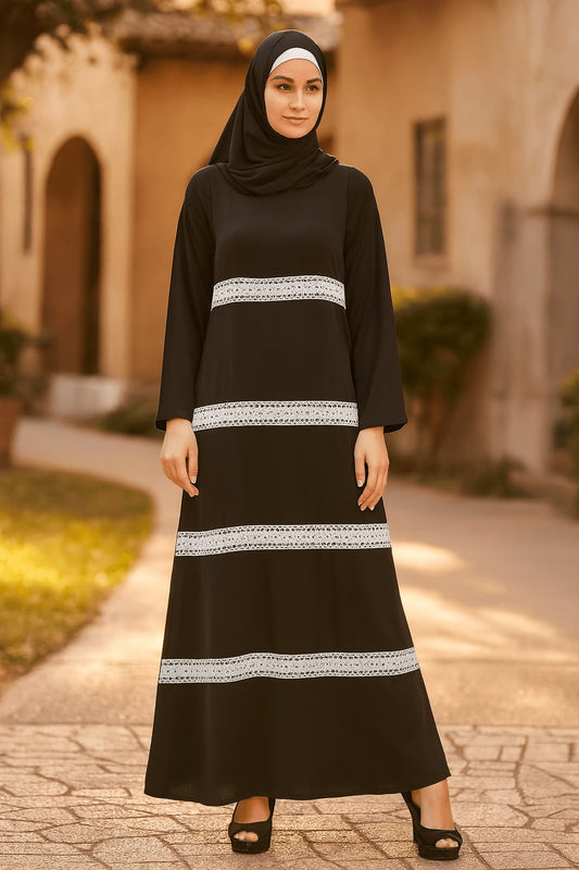 Woman wearing a black dress with white stripes outdoors.