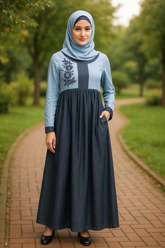 Woman wearing a blue and gray dress with a hijab in a park setting