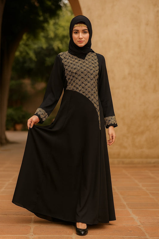 Woman wearing a black and patterned dress with hijab in an outdoor setting
