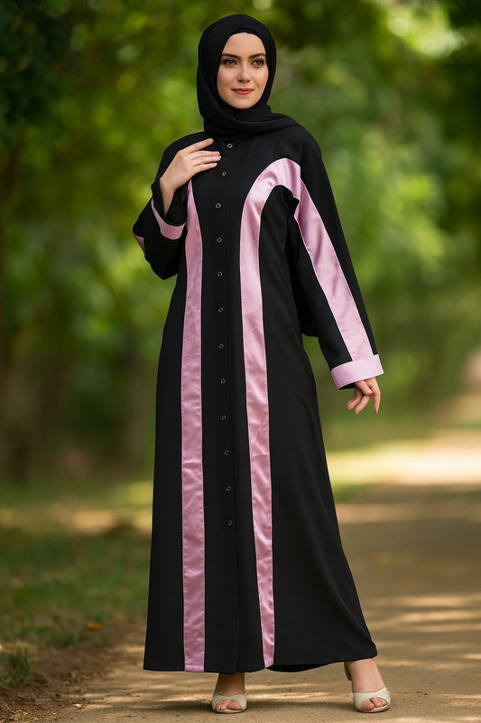 Woman wearing a black and pink abaya in a park setting