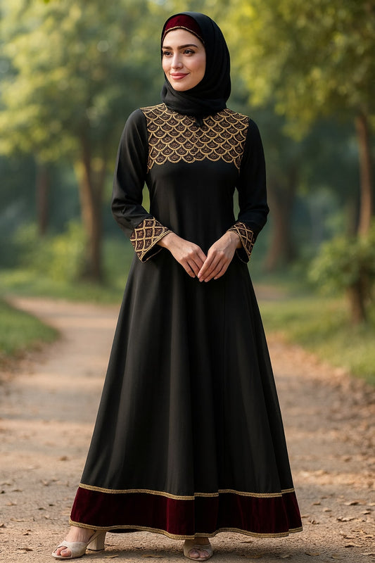 Woman wearing a black dress with gold embroidery standing on a path in a forest.