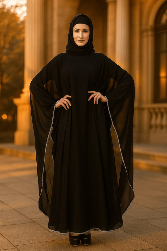 Woman wearing a black abaya in front of classical architecture