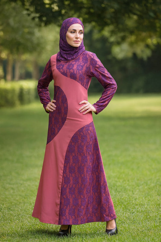 Woman wearing a long, patterned dress with a hood in an outdoor setting