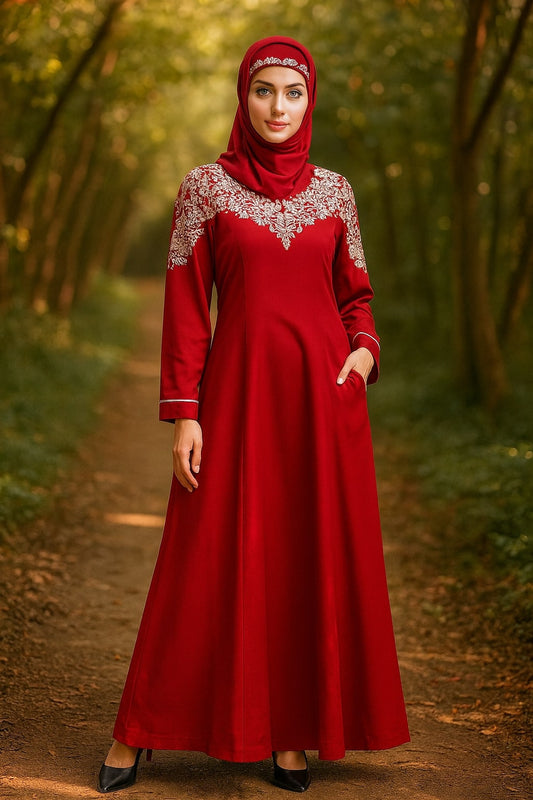 Woman wearing a red dress with lace details in a forest setting