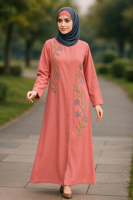 Woman wearing a pink dress with floral embroidery in an outdoor setting