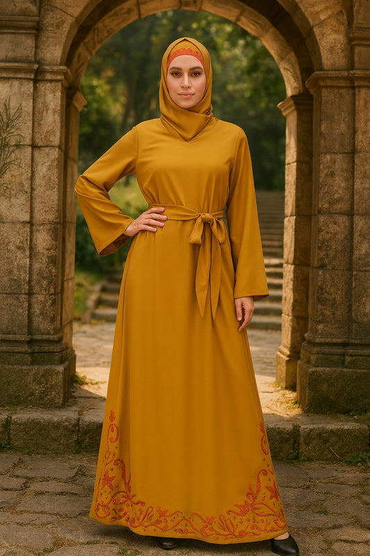 Woman in a mustard yellow dress with a hood standing in front of an archway.