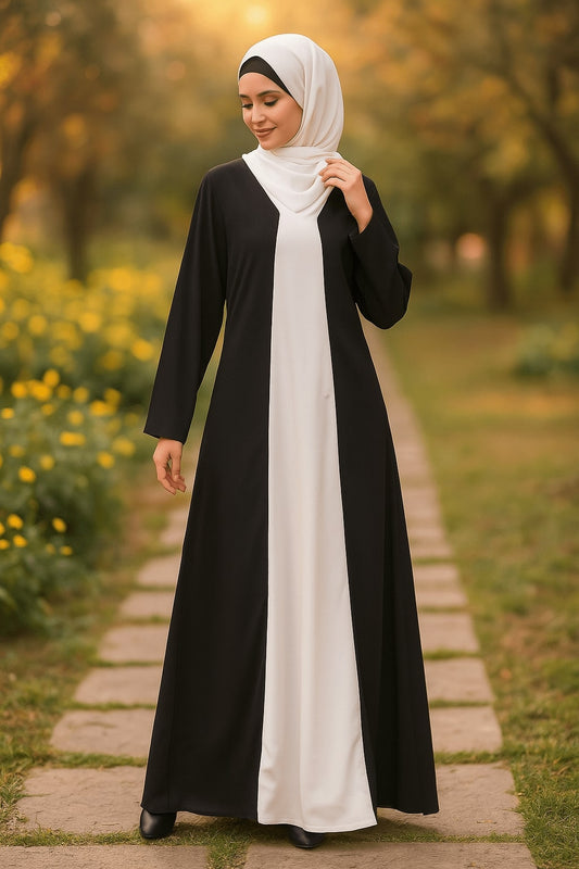 Woman wearing a black and white abaya in a park setting