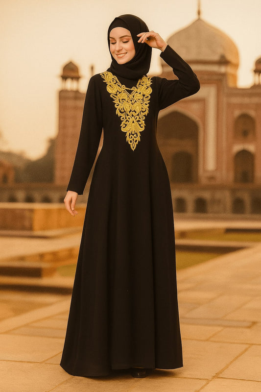 Woman wearing a black dress with gold embroidery in front of a historical building.
