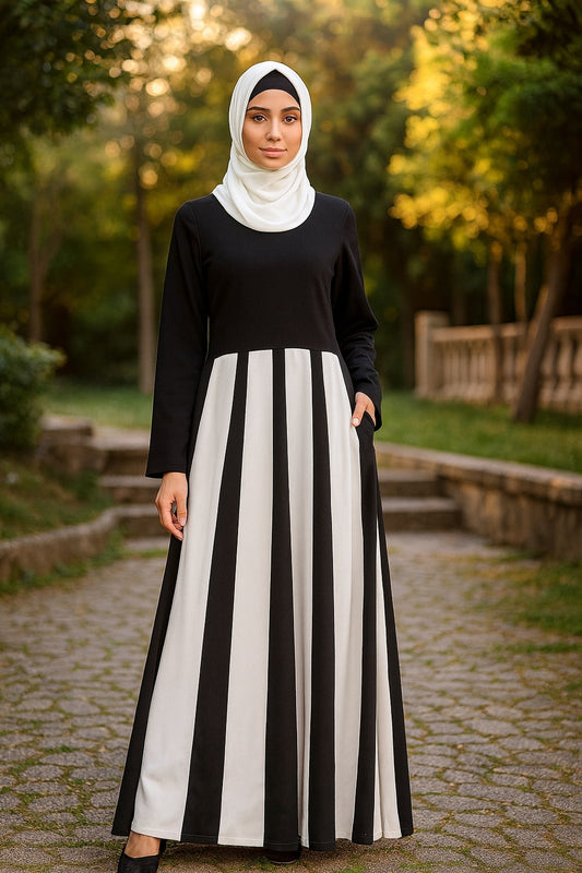 Woman wearing a black and white striped dress in a park setting