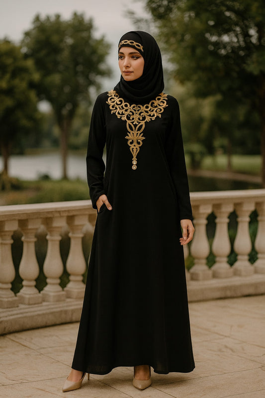 Woman wearing a black dress with gold embroidery standing outdoors.