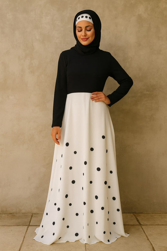 Woman wearing a black top and white skirt with black polka dots against a beige background