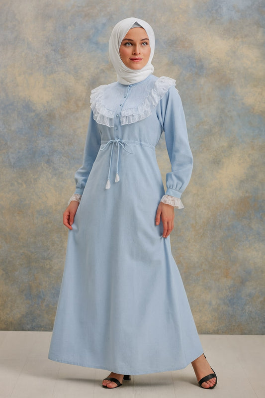 Woman wearing a light blue dress with lace details against a textured beige background
