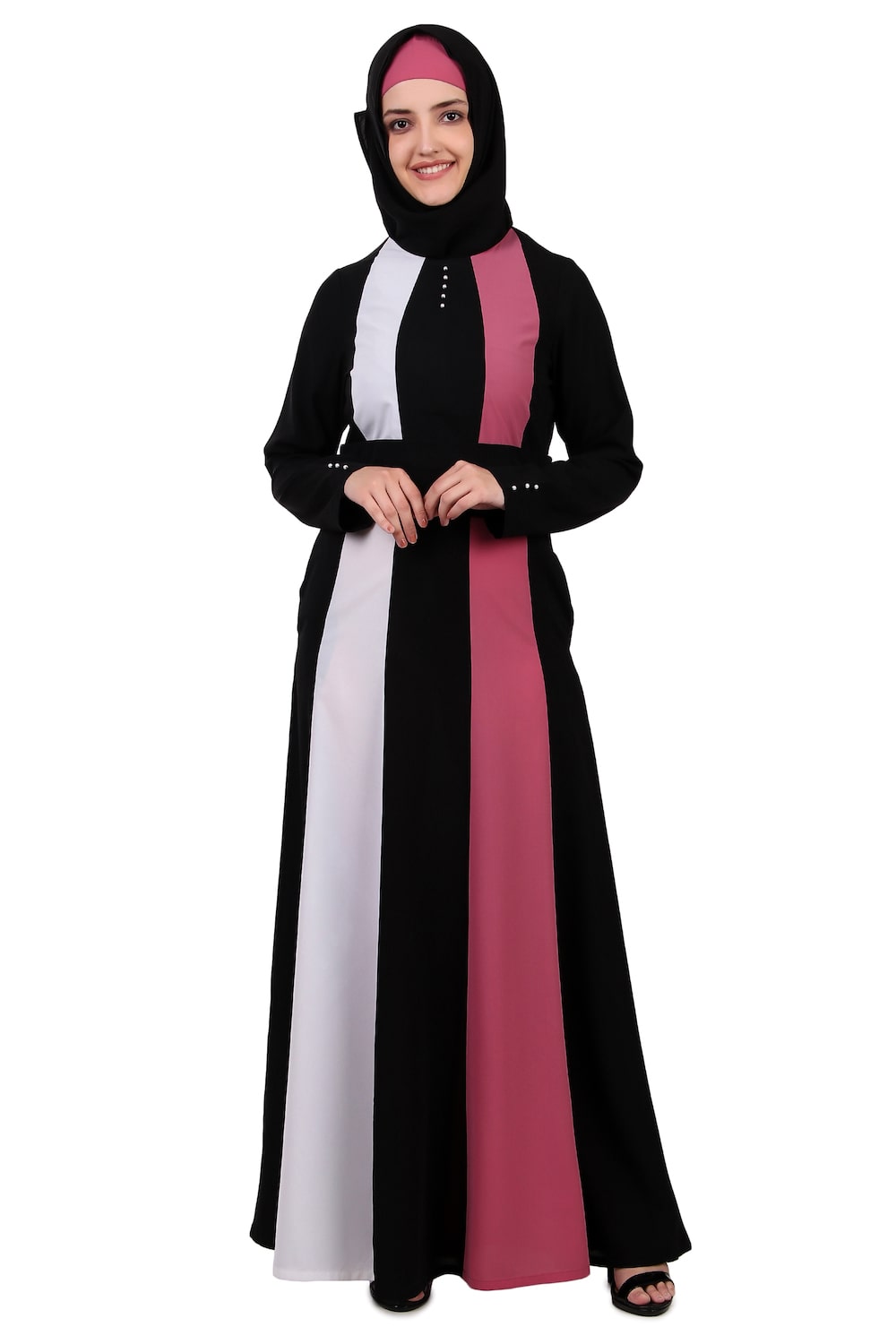 A woman wearing a multi-colored abaya with black, white, and pink panels, featuring a round neckline and sleeve details.