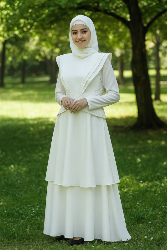 Woman in a white dress standing in a park with trees and grass in the background