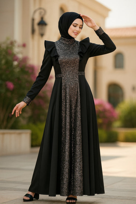 Woman wearing a black and silver dress with a hijab in an outdoor setting.