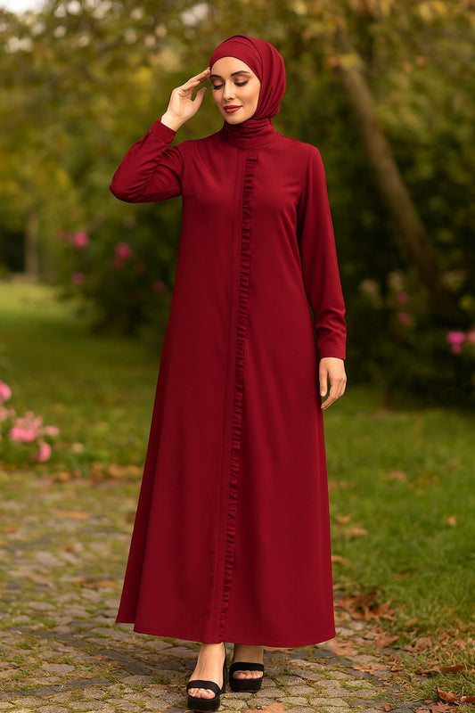 Woman wearing a burgundy dress with a hijab in a park setting
