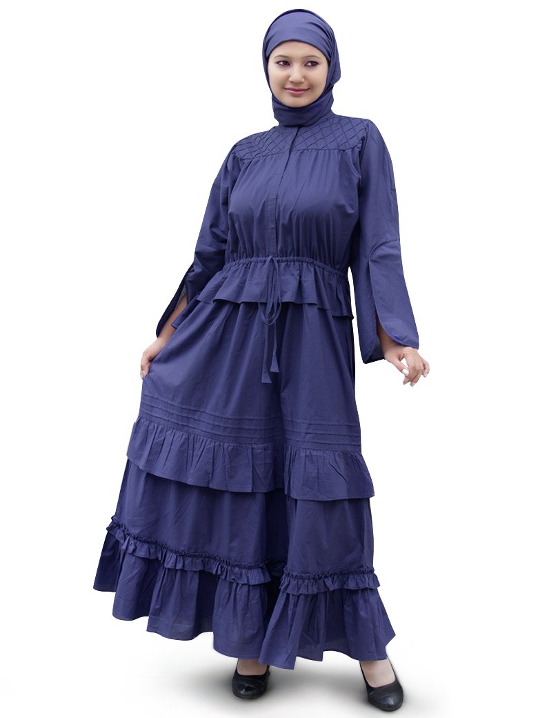 A woman wearing a blue Abal Abaya with layered frills and a square hijab.