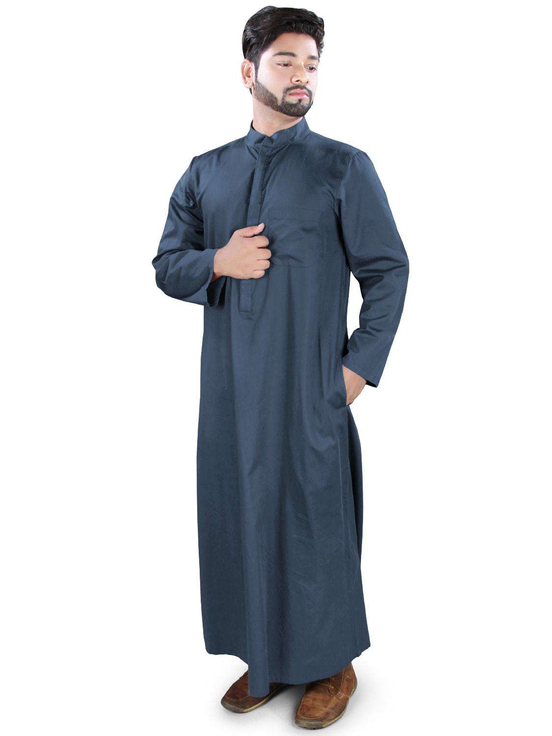 A man wearing a navy-blue Galabiyya with a hidden button placket, left chest pocket, and straight sleeves. The garment has utility pockets on both sides.