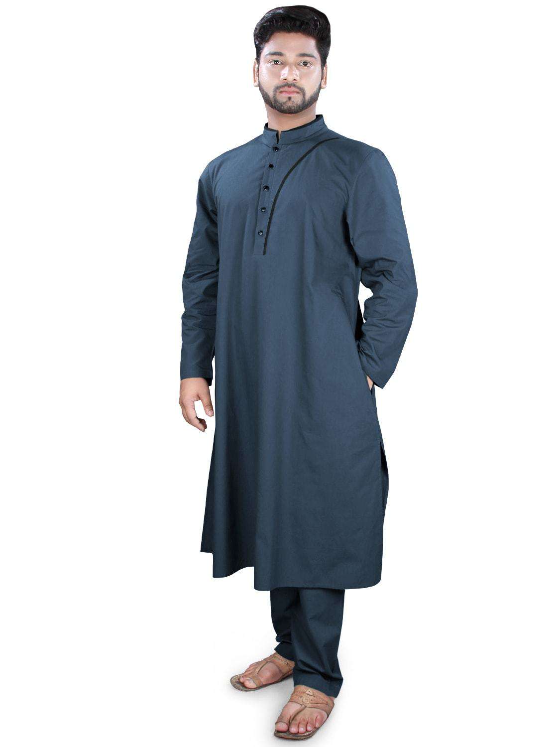 A man wearing a navy-blue kurta pajama set with a band collar neckline, front open placket with black contrast strip, and side openings. The pants have a drawstring waist and the outfit is completed with straight sleeves and utility pockets.