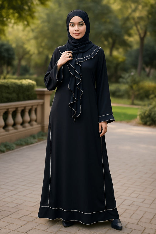 Woman wearing a black abaya with white trim in an outdoor setting