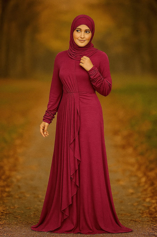 Woman wearing a long burgundy dress with a hijab in a forest setting