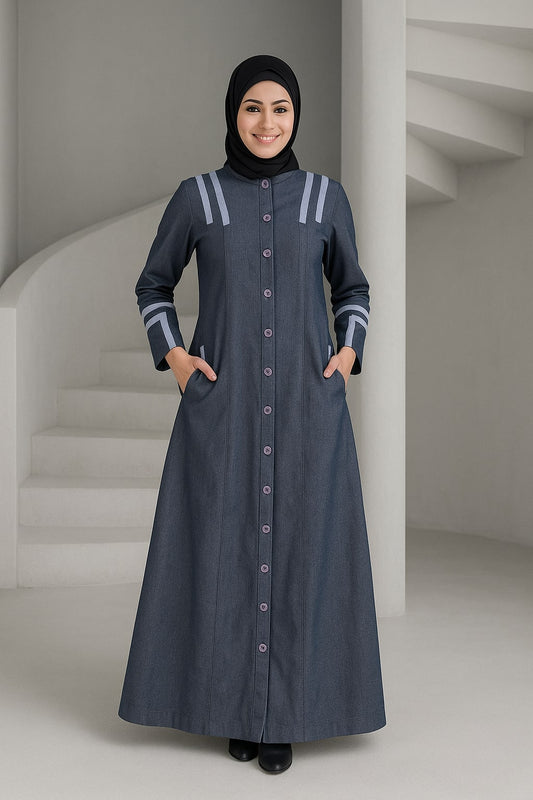 Woman wearing a long dark blue dress with white accents in a minimalistic setting.