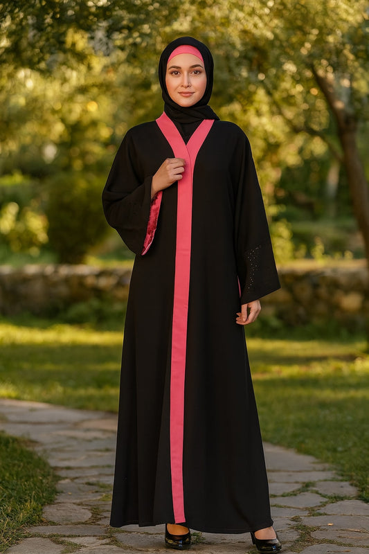Woman wearing a black abaya with a pink stripe in a park setting