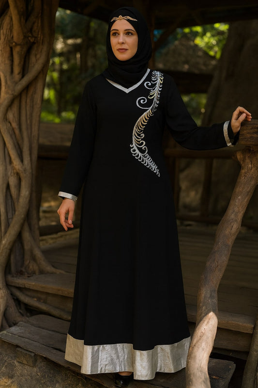 Woman in a black dress with white embroidery standing outdoors.
