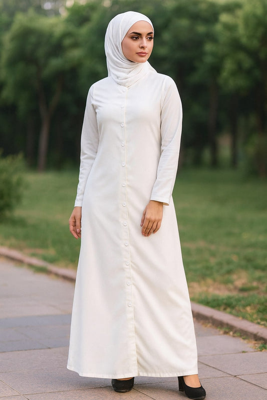 Woman wearing a white abaya in a park setting