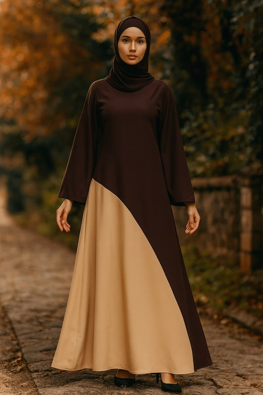 Woman wearing a brown and beige dress standing outdoors with trees in the background