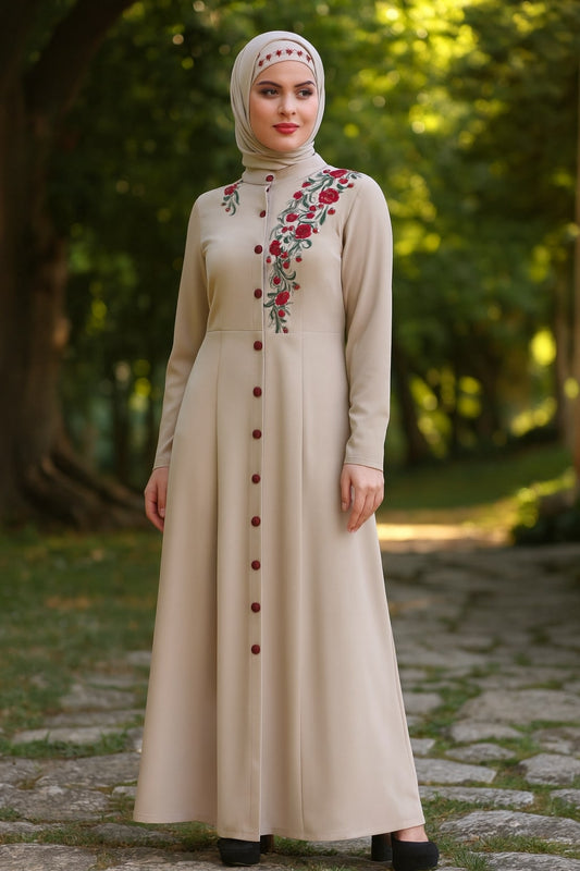 Woman wearing a beige dress with floral embroidery in an outdoor setting