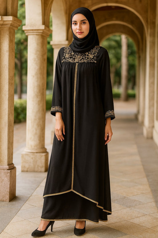 Woman wearing a black dress with gold embroidery in an outdoor setting