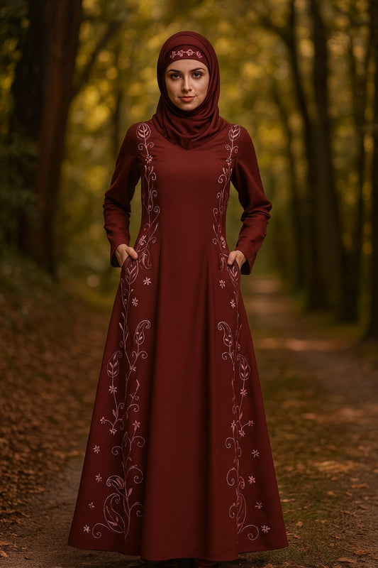 Woman wearing a burgundy dress with intricate patterns in a forest setting