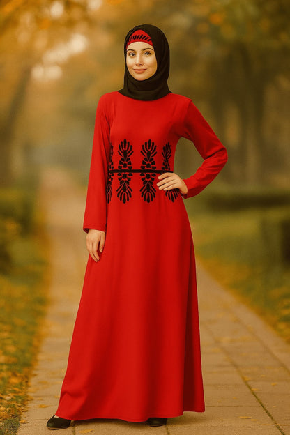 Woman wearing a red dress with black embroidery in an outdoor setting