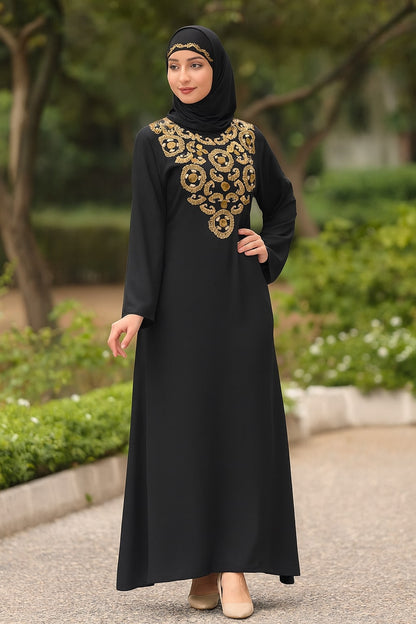 Woman wearing a black abaya with gold embroidery in an outdoor setting