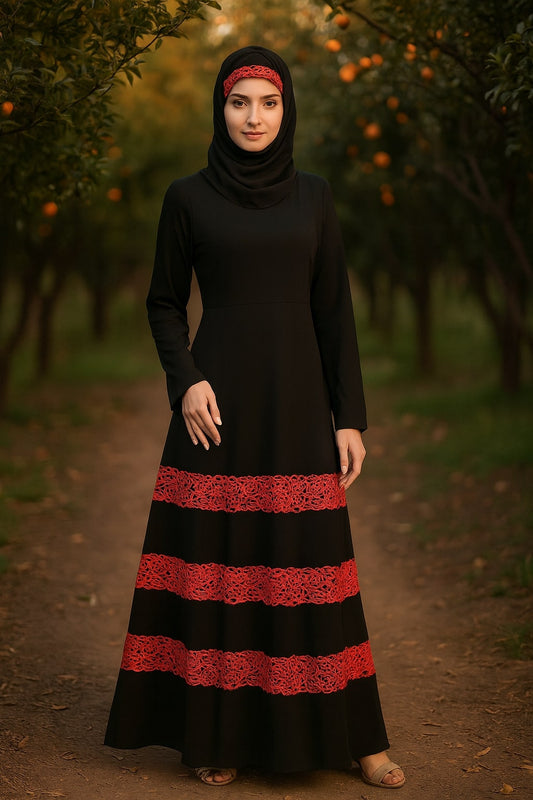 Woman wearing a black dress with red lace details in an outdoor setting.
