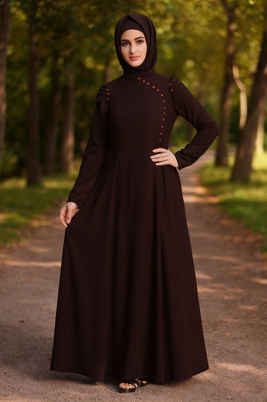 Woman wearing a dark brown dress with a hood in a forest setting