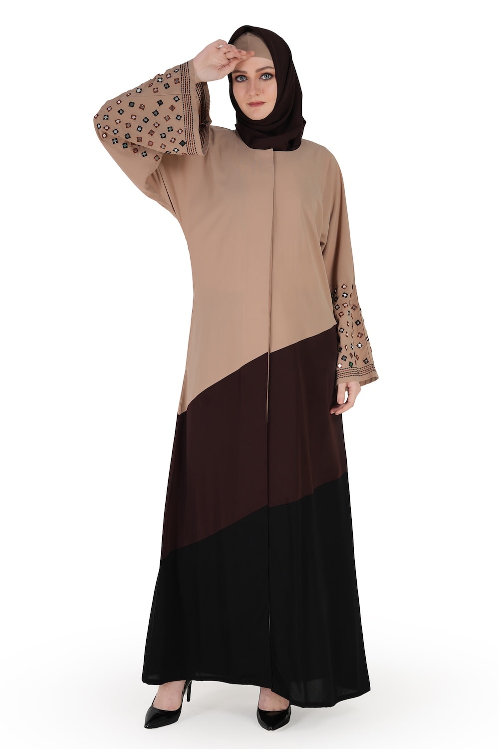 A model wearing a Dubai abaya with mirror work embroidery in warm grey, brown, and black colors. The abaya has a round neckline, straight sleeves with embroidery, and is paired with a matching headscarf.