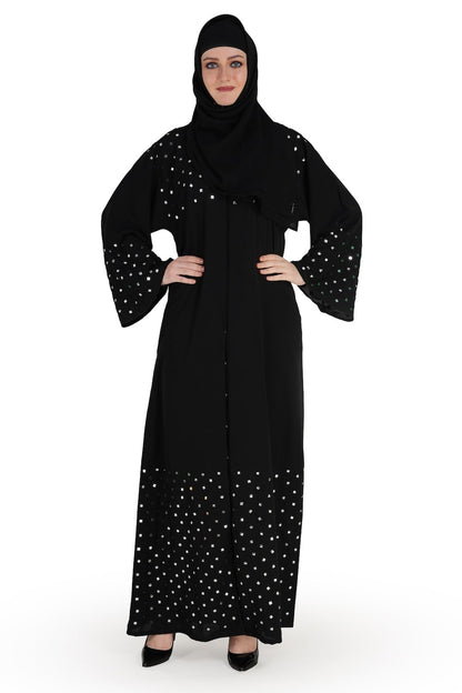 A model wearing a black abaya with mirror work embroidery, with a round neckline and straight sleeves. The abaya is fully visible, showing the front and side, with no visible face to protect the model's identity.