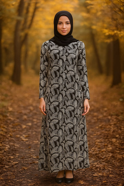 Woman in a long, patterned dress standing in an autumn forest.
