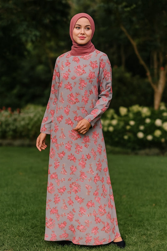 Woman wearing a gray dress with pink floral pattern outdoors.