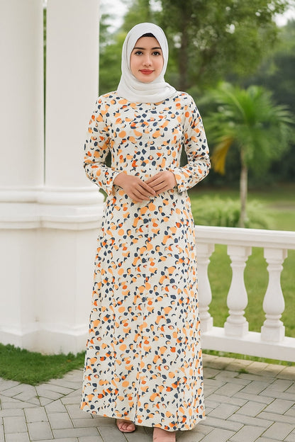 Woman wearing a floral dress with a hijab standing outdoors.