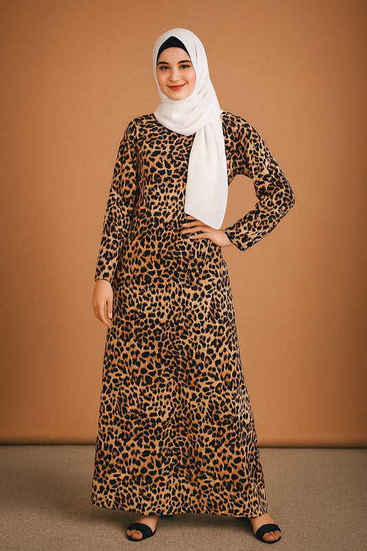 Woman wearing a leopard print dress with a white hijab against a brown background