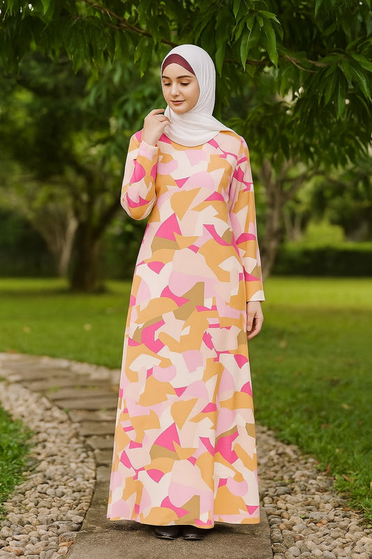 Woman wearing a colorful dress with geometric pattern standing outdoors on a path.