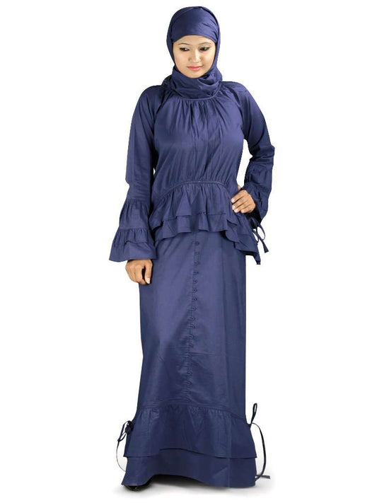 A woman wearing a navy blue abaya with balloon sleeves and frills at the neckline and waist.